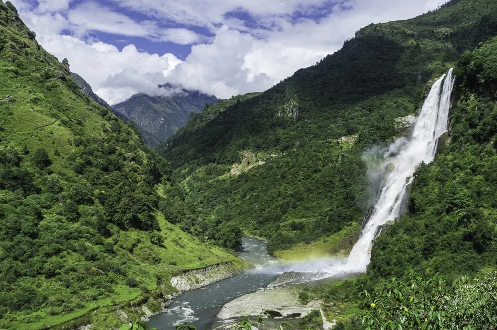 Waterfall cascading through forested mountains in Arunachal Pradesh